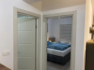 a bedroom with a door leading to a bed at Ulcinj Apartments in Ulcinj