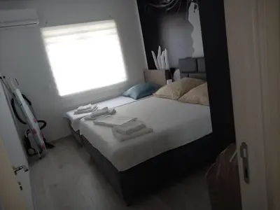 a bedroom with a large bed with a window at Ulcinj Apartments in Ulcinj