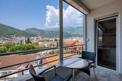 a balcony with a table and chairs and a view at Studio apartment in the centre of Budva in Budva
