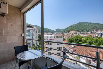 a balcony with a table and chairs and a view at Studio apartment in the centre of Budva in Budva