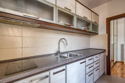 a kitchen with white cabinets and a sink at Studio apartment in the centre of Budva in Budva