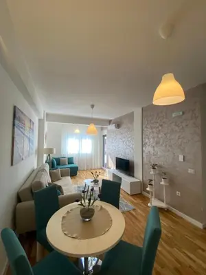 a living room with a table and a couch at Crown Apartment in Ulcinj