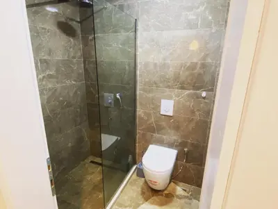 a bathroom with a toilet and a glass shower at Crown Apartment in Ulcinj