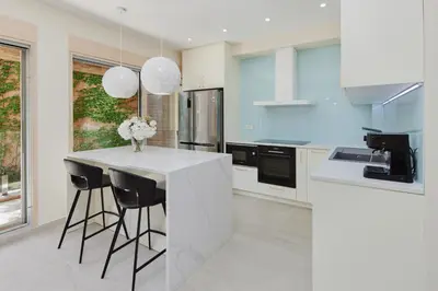 a kitchen with a white counter and black appliances at Huge Apartment with Stunning View and Sauna in Kotor