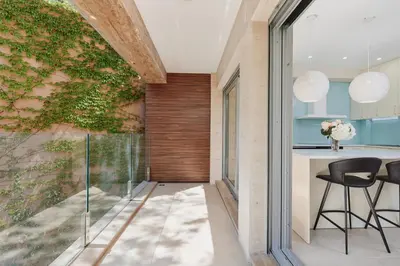 a dining room with a green wall at Huge Apartment with Stunning View and Sauna in Kotor