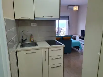 a kitchen with a sink and a counter top at Apartments Relax in Utjeha
