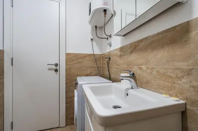 a bathroom with a sink and a mirror at Aura Tower Aparments by In Property in Rafailovici