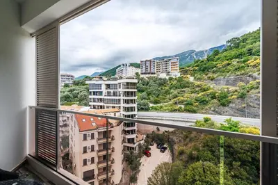 a balcony with a view of a city and mountains at Aura Tower Aparments by In Property in Rafailovici