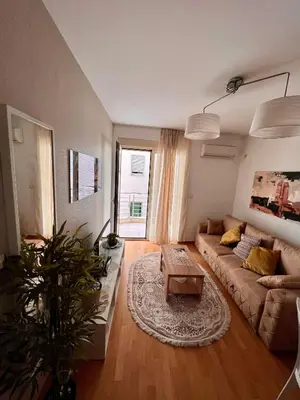 a living room with a couch and a table at City Centre Getaway in Budva
