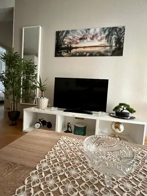 a living room with a flat screen tv on a white entertainment center at City Centre Getaway in Budva