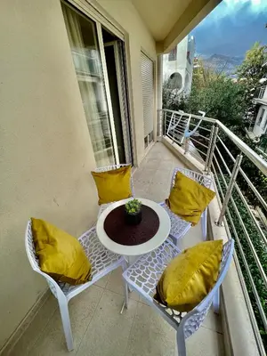 a balcony with a table and chairs on a balcony at City Centre Getaway in Budva