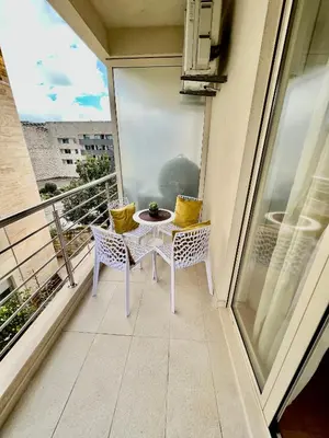 a balcony with a table and chairs on a balcony at City Centre Getaway in Budva