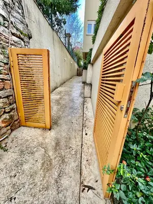 an entrance to a building with an orange gate at City Centre Getaway in Budva