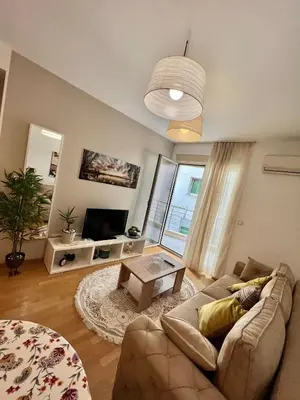 a living room with a couch and a table at City Centre Getaway in Budva