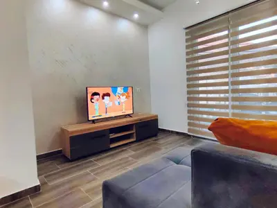 a living room with a flat screen tv on a table at Mialex apartments in Dobra Voda