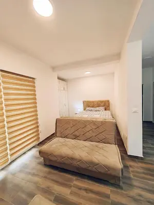 a bedroom with two beds and a large window at Mialex apartments in Dobra Voda