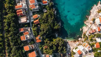 an aerial view of houses on a hill next to the ocean at Villa Maren in Utjeha