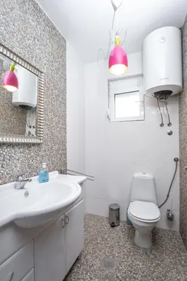 a bathroom with a sink and a toilet and a mirror at Villa Maren in Utjeha