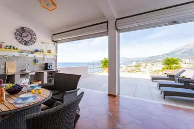 a kitchen and living room with a view of the ocean at Villa Maren in Utjeha