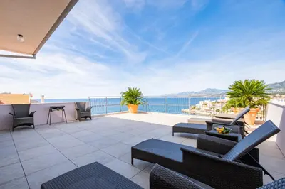 a patio with chairs and a view of the ocean at Villa Maren in Utjeha