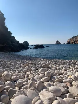 a large group of rocks on a beach near the water at Villa Maren in Utjeha