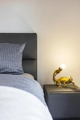 a toy lizard on a night stand next to a bed at Villa Maren in Utjeha