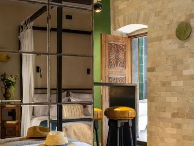 a room with bunk beds and a table with hats at La Mia Amore in Kotor