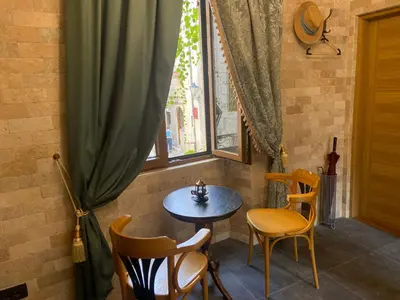 a table and chairs in a room with a window at La Mia Amore in Kotor