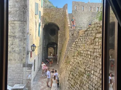 a group of people walking down an alley in a castle at La Mia Amore in Kotor