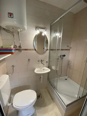 a bathroom with a shower and a toilet and a sink at Apartman Sedmica in Danilovgrad