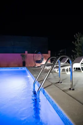 a swimming pool with a slide in the water at Apartman Sedmica in Danilovgrad