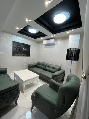 a living room with couches and a table and lights at Cezar Apartments in Podgorica