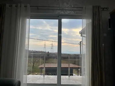 a window with a view of a house at Cezar Apartments in Podgorica