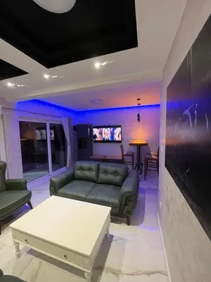a living room with a couch and a table at Cezar Apartments in Podgorica