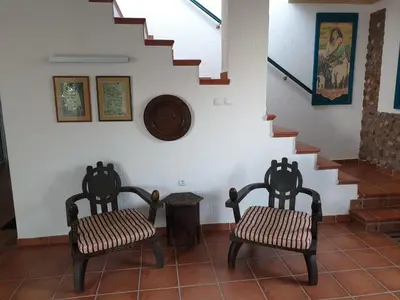 two chairs sitting in a room with a staircase at Villa Frida in Sveti Stefan