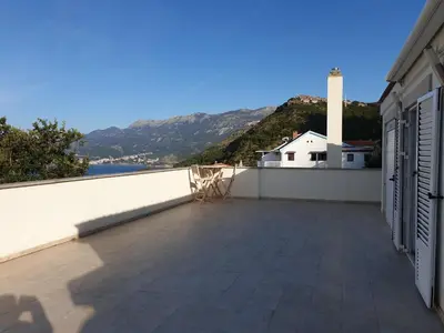 a balcony with a view of the water and mountains at Villa Frida in Sveti Stefan