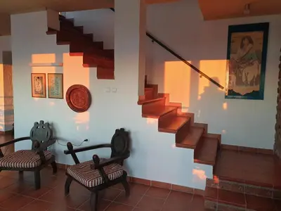 a room with two chairs and a staircase at Villa Frida in Sveti Stefan