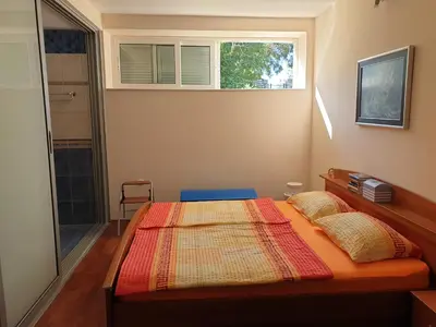 a bedroom with a bed and a window at Villa Frida in Sveti Stefan