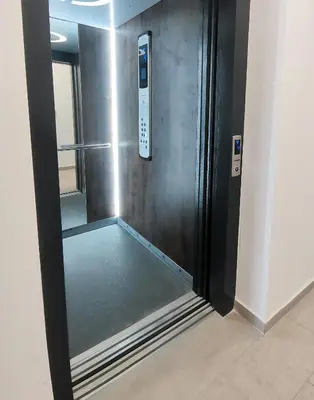 a elevator with a glass door in a room at Stylish One Bedroom Apartment in Podgorica