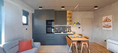 a living room with a blue couch and a table at Stylish One Bedroom Apartment in Podgorica