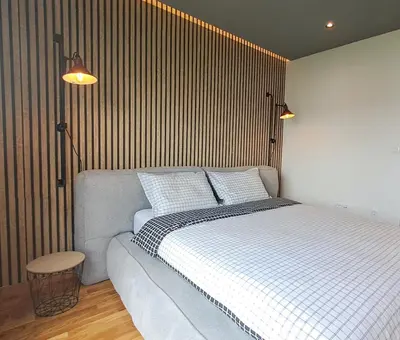 a bedroom with a large bed with two pillows at Stylish One Bedroom Apartment in Podgorica