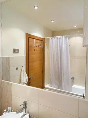 a bathroom with a mirror and a sink and a shower at Sunny apartment in Becici