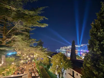 a view of a city at night with lights at The New Hotel Mediteran - VILLA Edition in Ulcinj