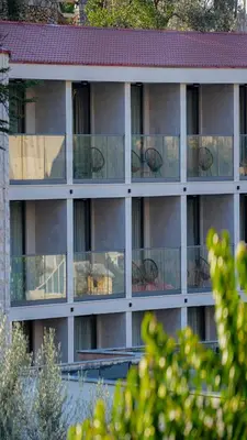 an apartment building with glass balconies on the side at The New Hotel Mediteran - VILLA Edition in Ulcinj