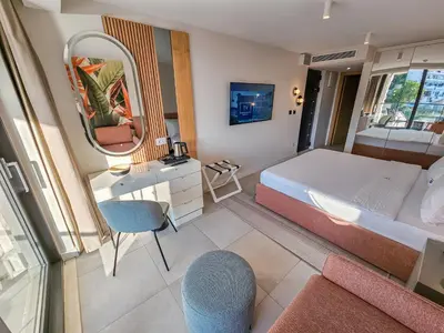a bedroom with a bed and a mirror at The New Hotel Mediteran - VILLA Edition in Ulcinj