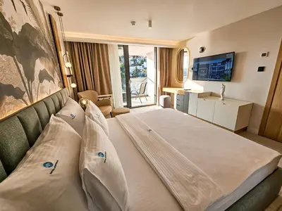 a large bed in a room with a window at The New Hotel Mediteran - VILLA Edition in Ulcinj
