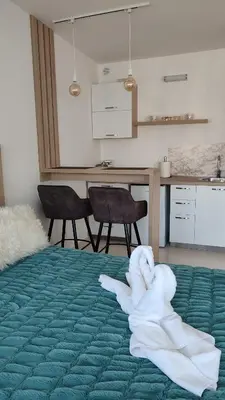 a room with a bed with a towel on it at Apartmani Stari Aerodrom in Podgorica