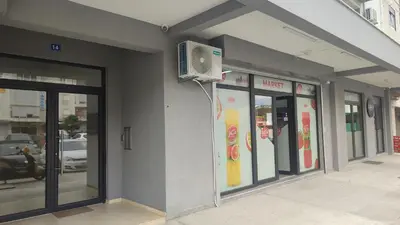 a building with a tv on the side of it at Apartmani Stari Aerodrom in Podgorica