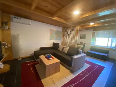 a living room with a couch and a coffee table at Cute lodge in Zeta in Mahala
