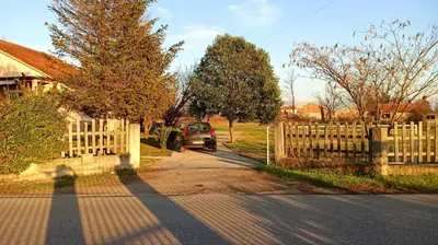 a car driving down a road next to a fence at Cute lodge in Zeta in Mahala
